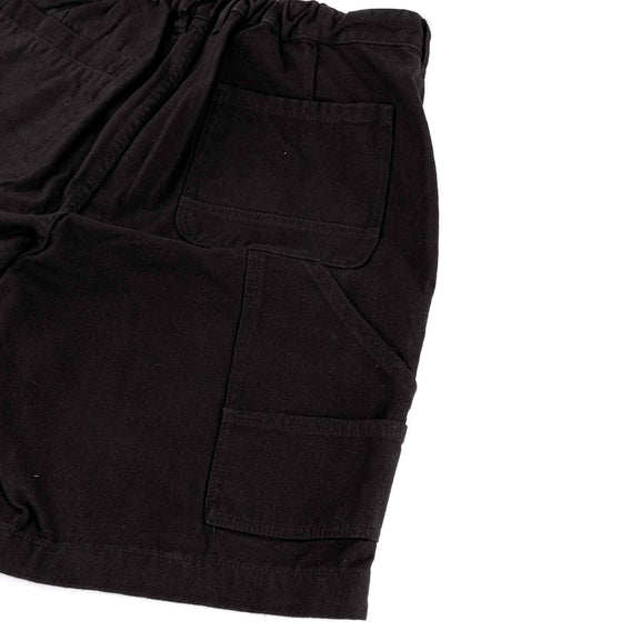 Close-up of black shorts with two front pockets on a white background