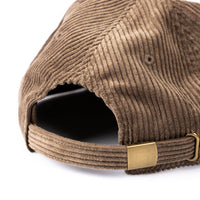 Brown corduroy cap with a gold buckle on a white background