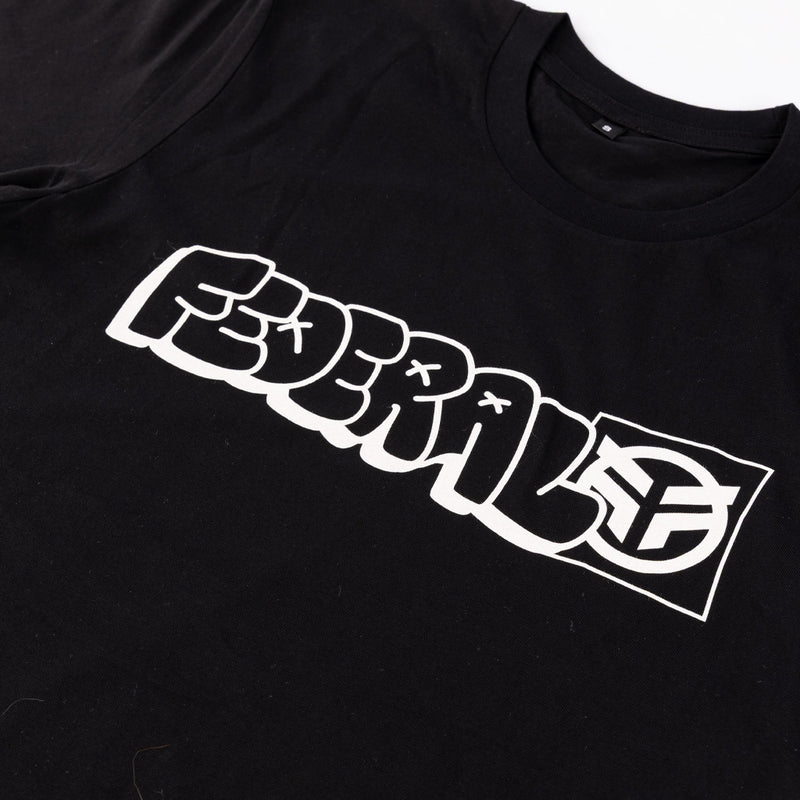 Black t-shirt with white graphic design on a plain background